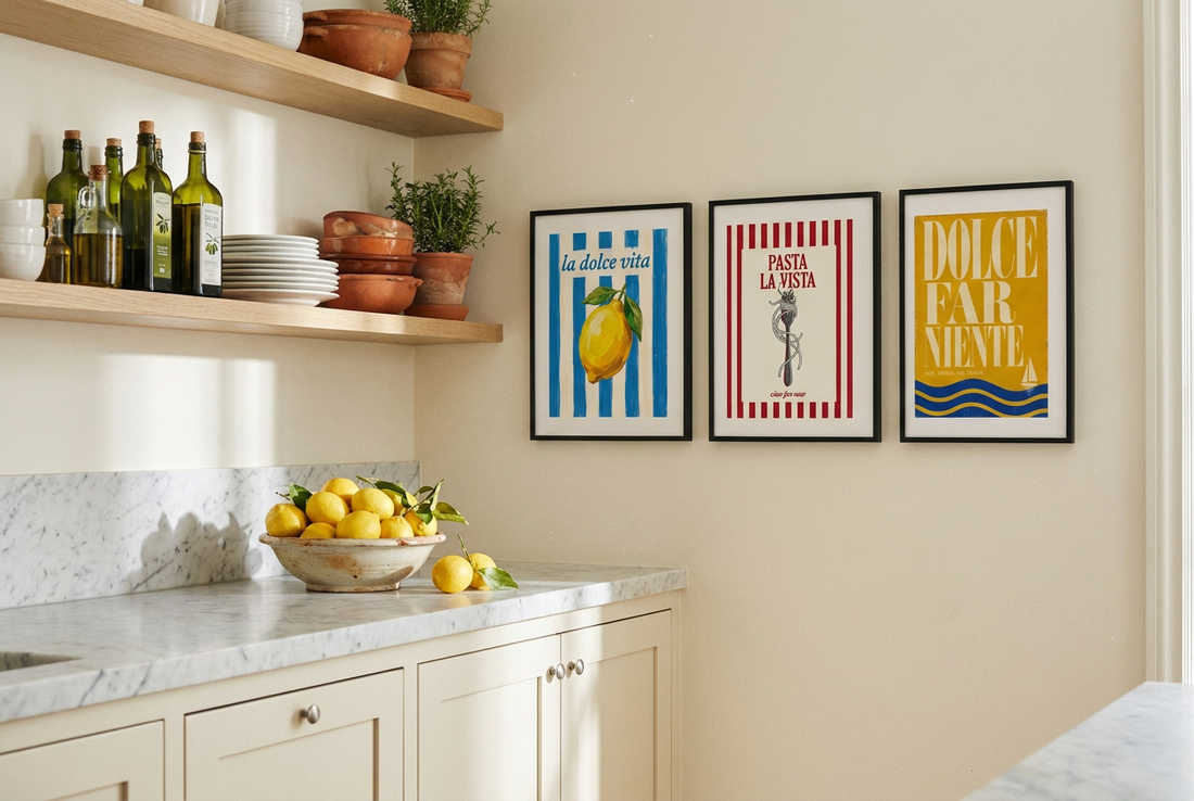Three Italian kitchen prints in black frames beside open shelves with olive oil and lemons