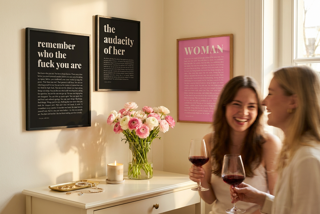 Bedroom gallery wall with three empowerment typography prints and two women laughing